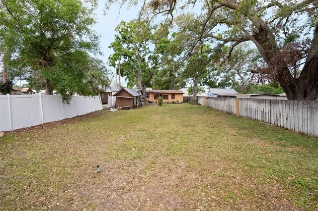 a view of a yard with swimming pool