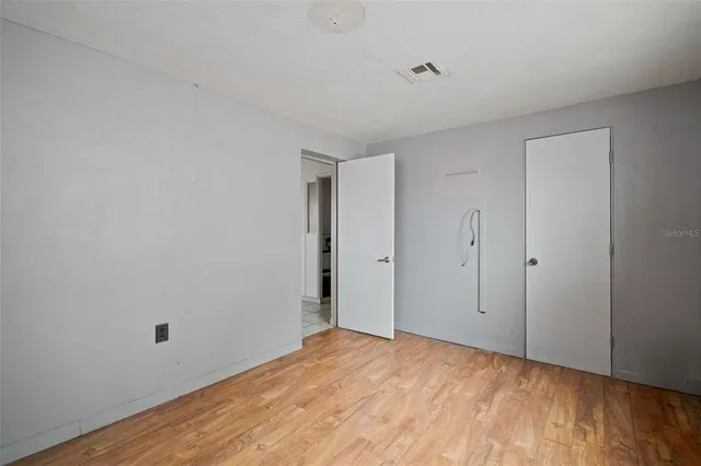a view of an empty room and wooden floor