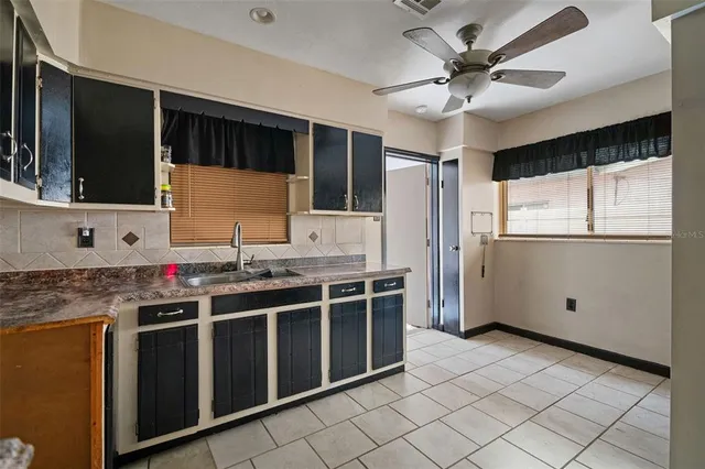 a kitchen with stainless steel appliances granite countertop a sink and a refrigerator