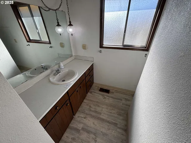 an empty room with windows and closet