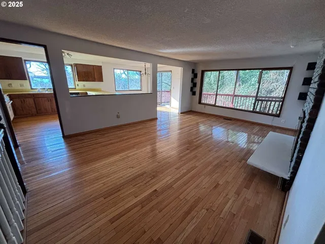 a view of a livingroom with wooden floor and staircase