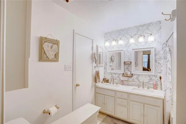 a bathroom with a double vanity sink and a mirror