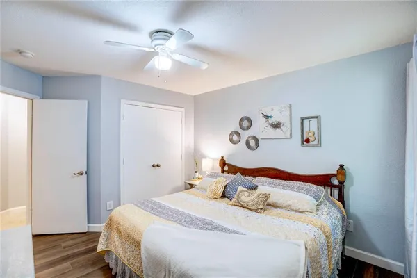 a bedroom with a large bed and a chandelier