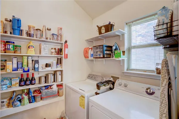 a room with furniture a small book shelf and a window