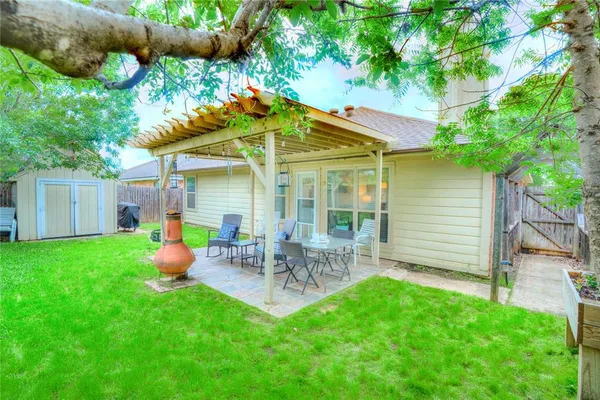 a front view of house with a garden and patio