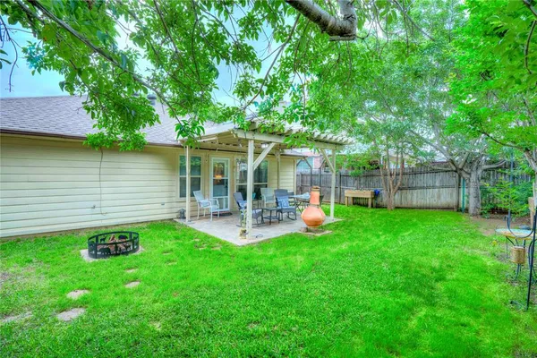 a view of a house with backyard porch and sitting area