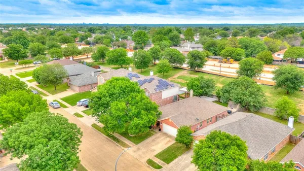 an aerial view of residential houses with outdoor space