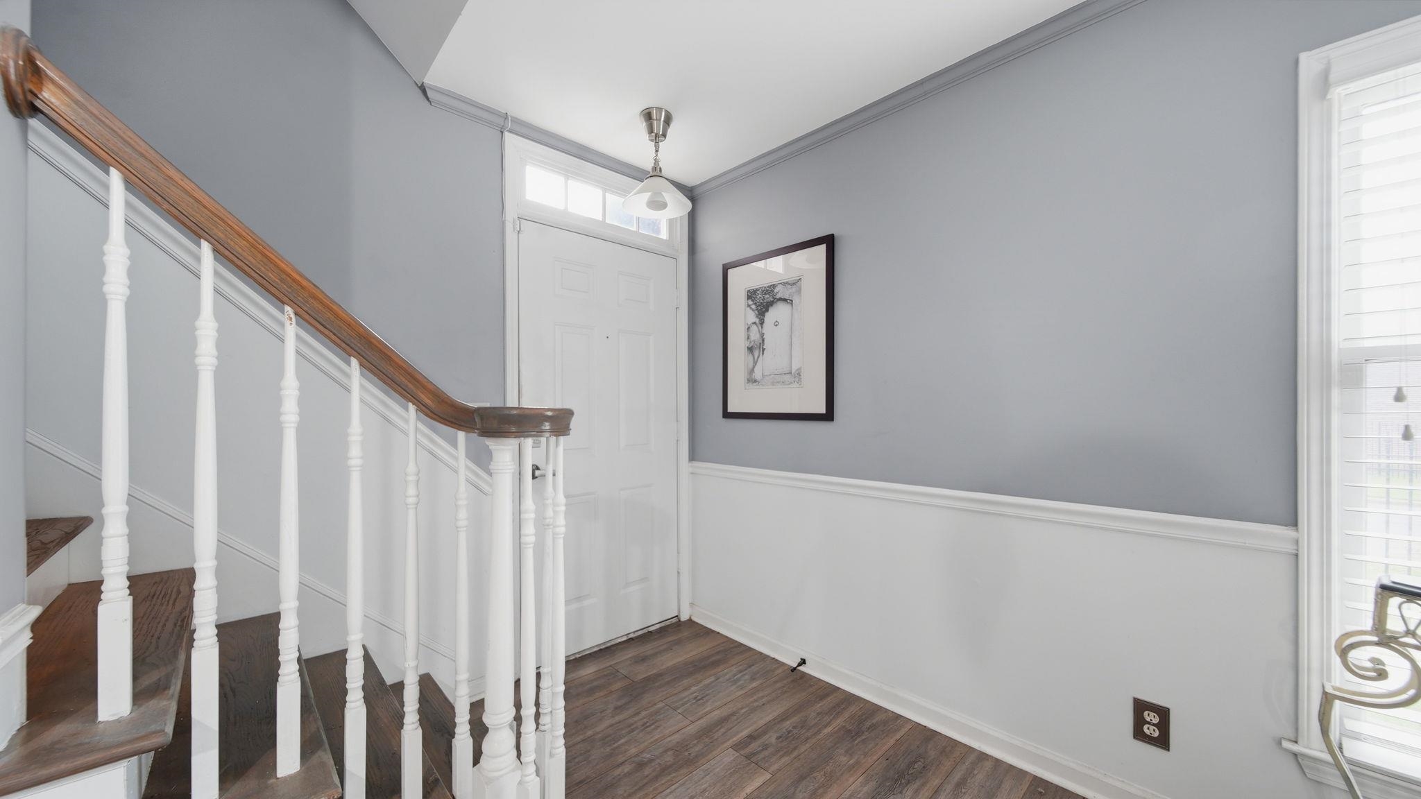 5866 Roxbury Drive, Unit 5866 Memphis, TN 38119 - Photo 2 of 20 Foyer featuring wood-finish flooring, wainscoting, and a multi-pane front door with transom window