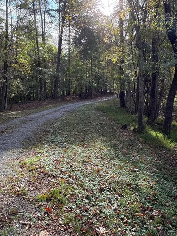 a view of dirt yard with a building