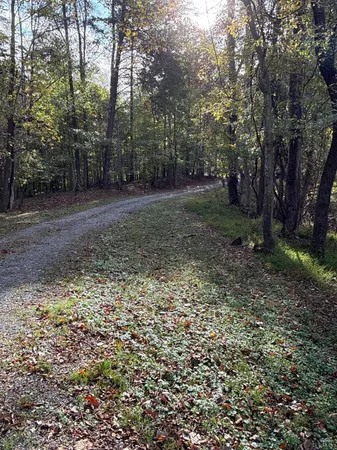 a view of dirt yard with a building