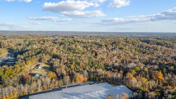 an aerial view of residential building with green space