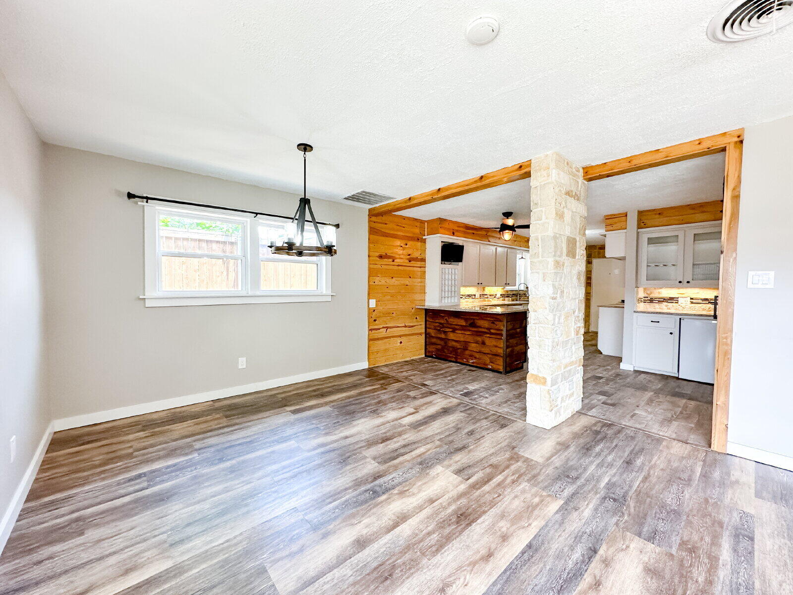 2608 Raleigh Avenue Lubbock, TX 79410 - Photo 19 of 23 a view of a kitchen with wooden floor a sink and windows