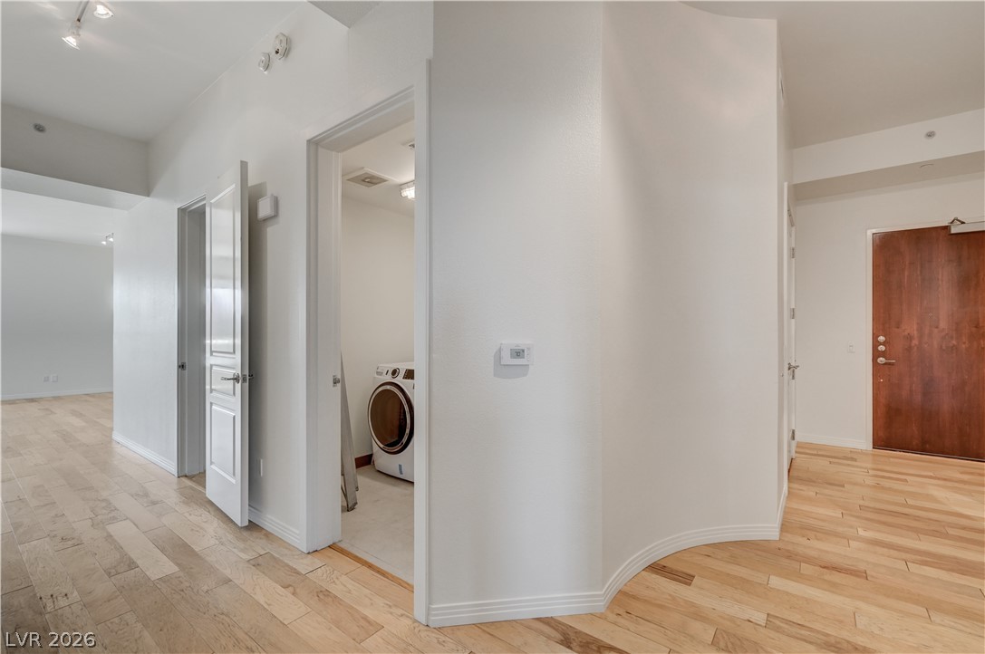 360 East Desert Inn Road, Unit 402 Las Vegas, NV 89109 - Photo 30 of 40 Discover convenience in this well-appointed utility area, featuring a stacked washer and dryer unit.