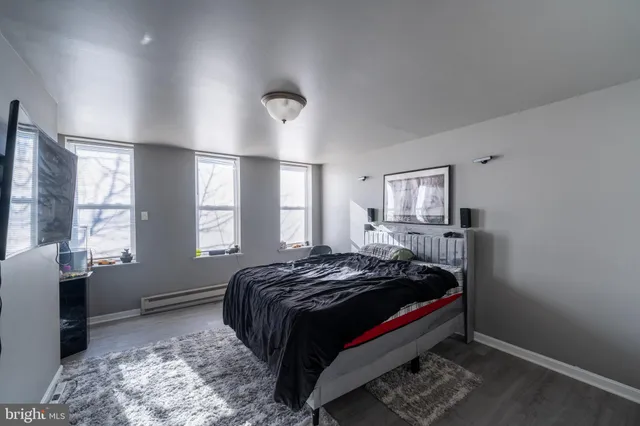 a bedroom with a bed and flat screen tv