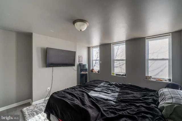 a bedroom with a bed and a flat screen tv