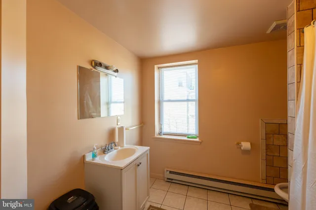 a bathroom with a shower and a shower curtain