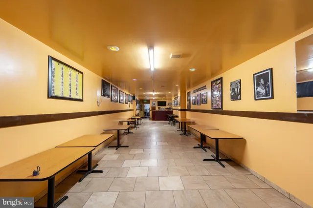 a living room with furniture a kitchen view and a window