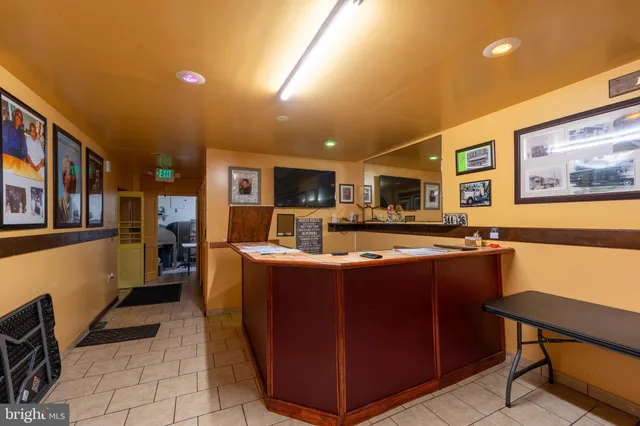 a utility room with stainless steel appliances wooden floor and view living room