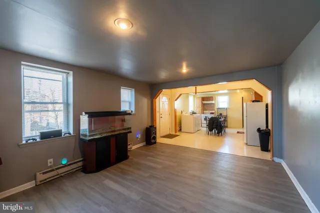 a view of a livingroom with furniture wooden floor and windows