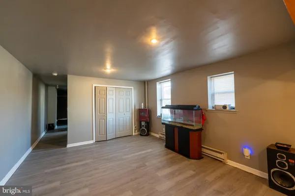 an empty room with piano and wooden floor