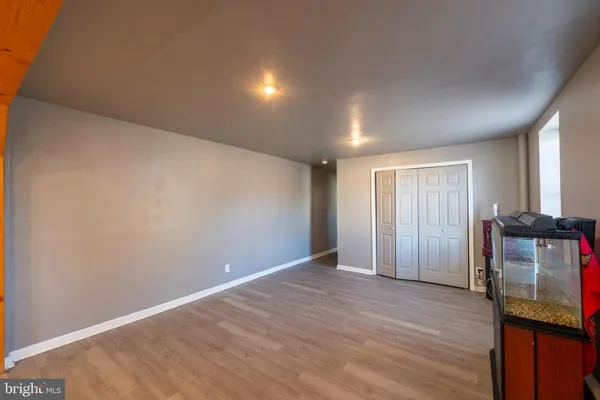 a room with stainless steel appliances kitchen island granite countertop a table chairs in it and a window