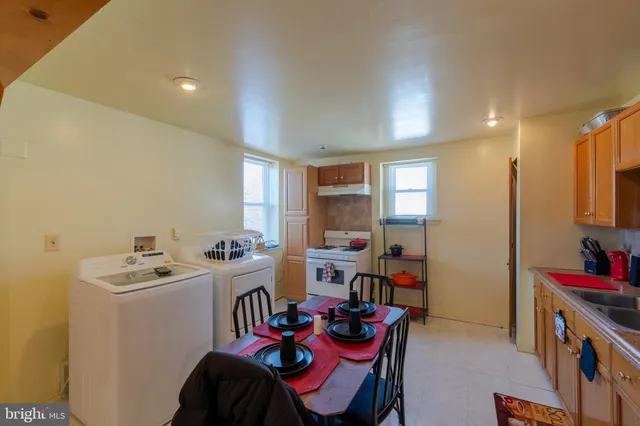 a dining room with furniture and a kitchen view
