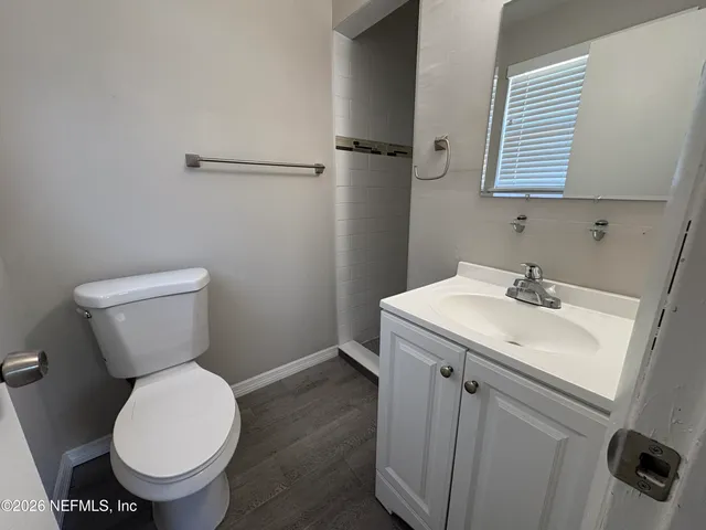 a bathroom with a toilet sink and a mirror