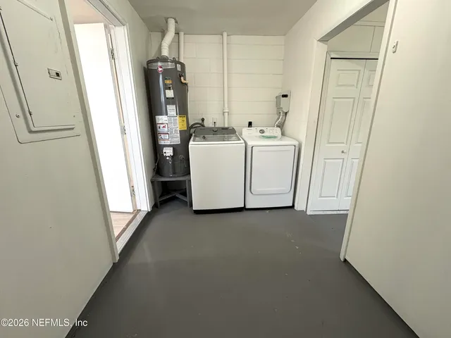 a utility room with closet a washer and dryer