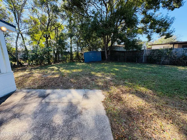 a backyard of a house with lots of green space