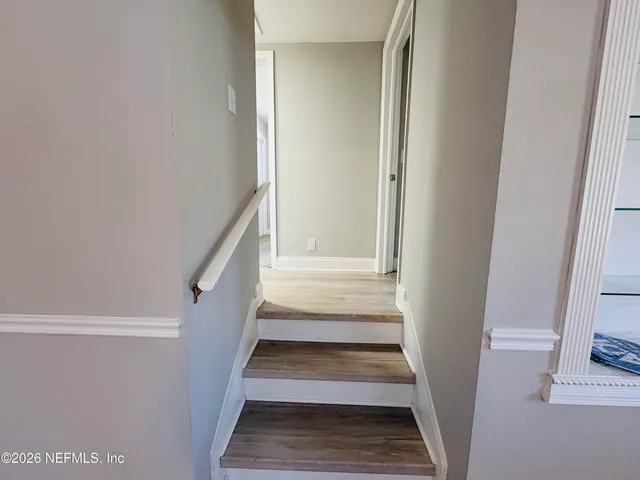 a view of staircase with white walls and a window