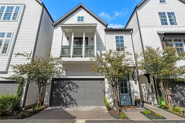 a front view of a house with a tree