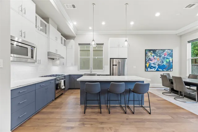 a kitchen with a sink and wooden floor