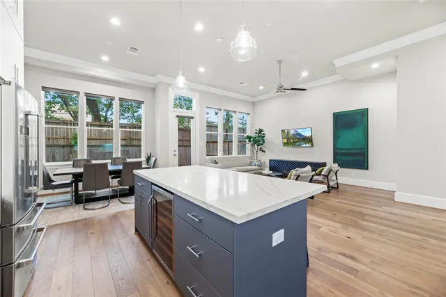 a large dining hall with stainless steel appliances granite countertop a stove and a dining table