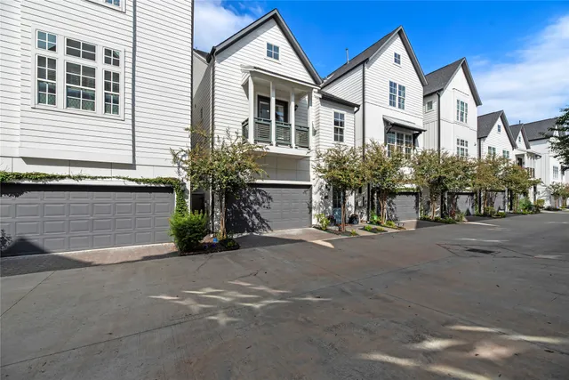 a front view of a house with yard and parking