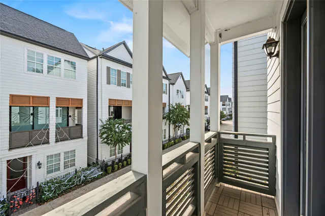 a view of a porch with wooden floor and windows