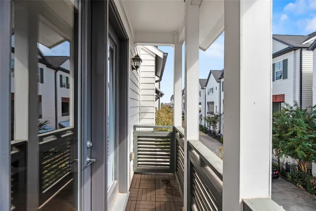 a view of a porch with wooden floor and iron stairs