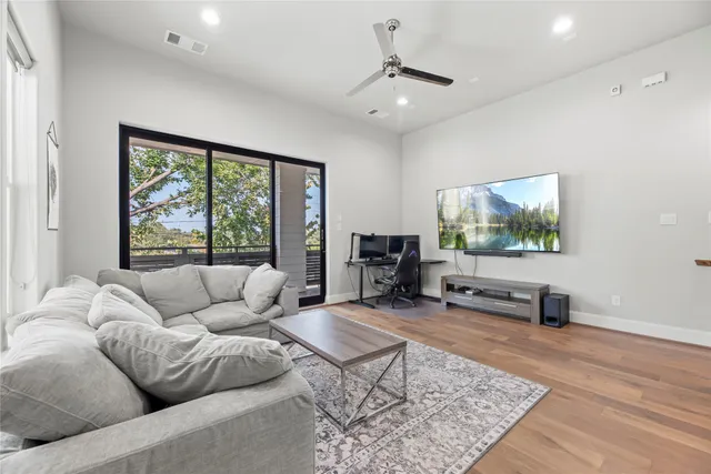 a view of a house with a large window and wooden fence