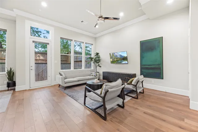 a living room with furniture and a potted plant