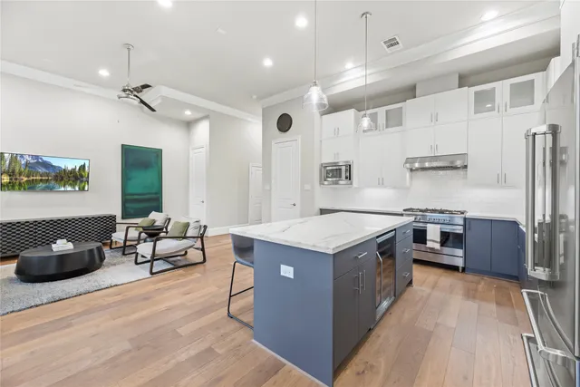 a stove top oven sitting inside of a kitchen