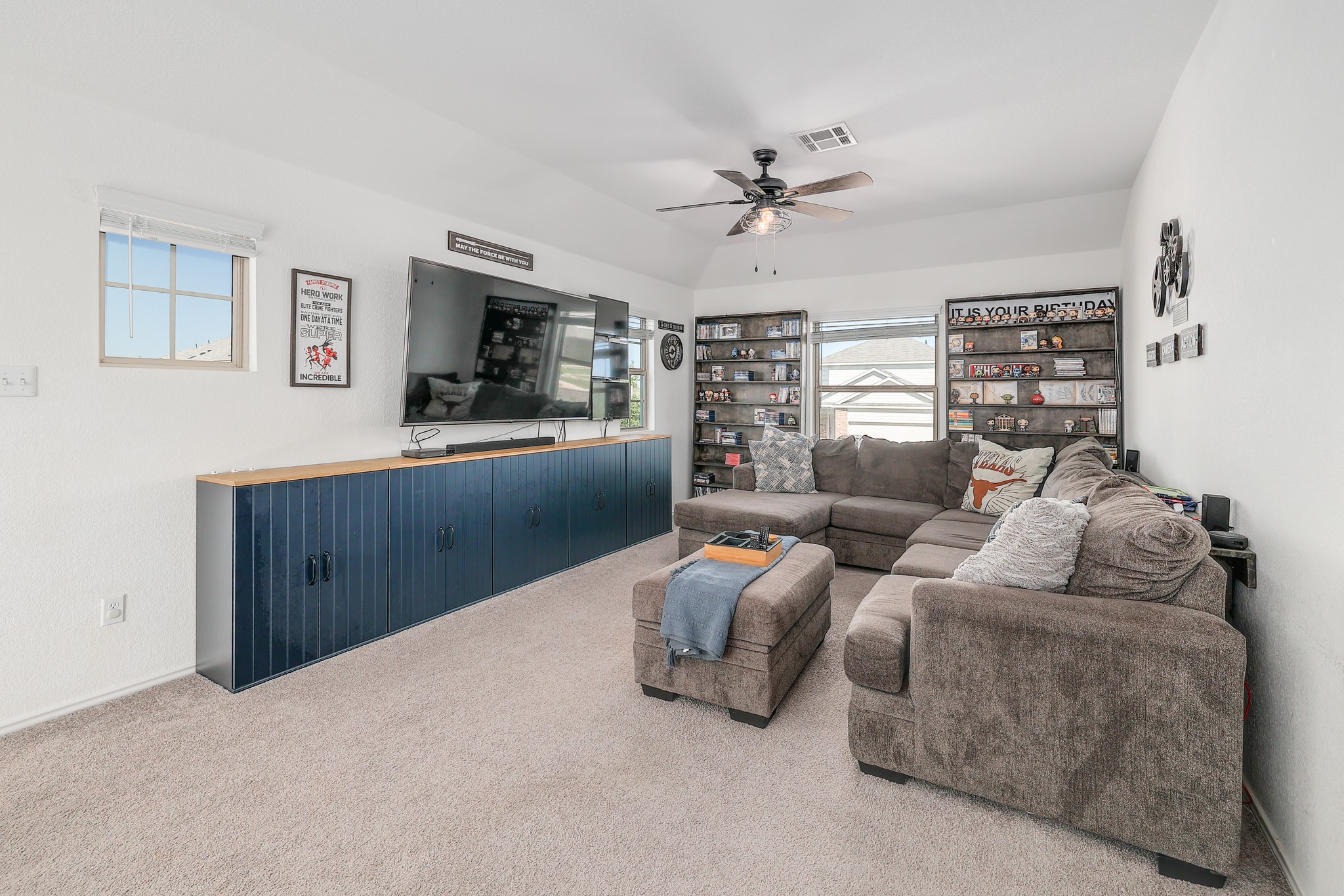 735 Circle Way Jarrell, TX 76537 - Photo 15 of 32 A spacious living area features high tray ceilings, neutral carpeting, and built-in shelving.