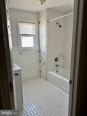 a bathroom with a bathtub a toilet and a shower