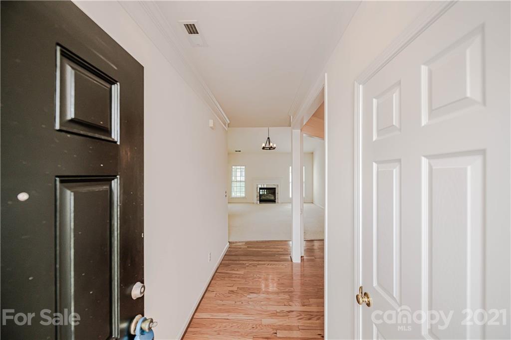 4928 Missi Lane, Unit 471 Fort Mill, SC 29708 - Photo 3 of 32 a view of a hallway with wooden floor and staircase