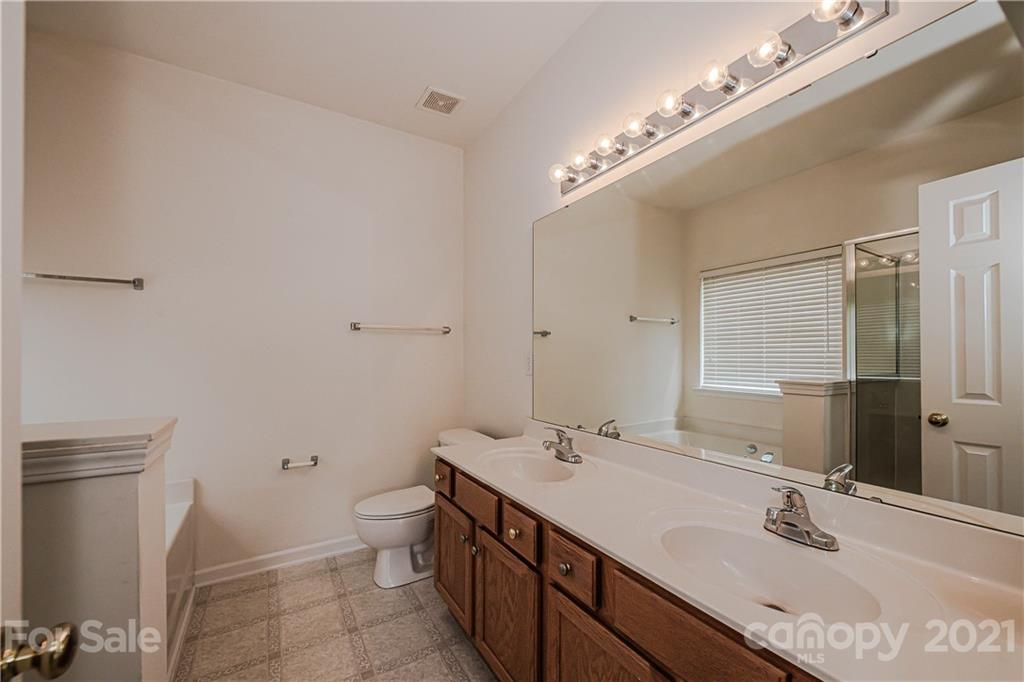4928 Missi Lane, Unit 471 Fort Mill, SC 29708 - Photo 22 of 32 a bathroom with a double vanity sink mirror and toilet