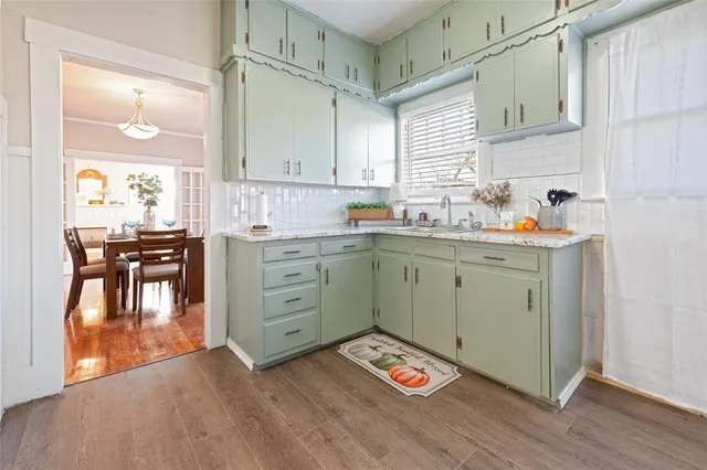 a spacious bedroom with a bed and wooden floor