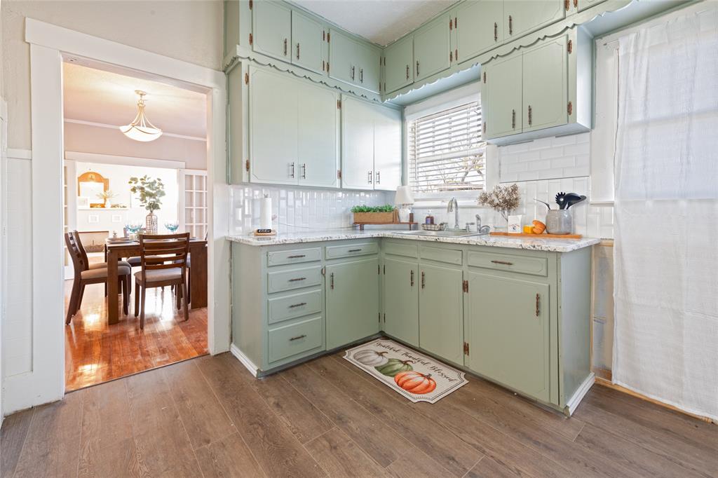 449 Clinton Street Abilene, TX 79603 - Photo 16 of 34 a kitchen with a sink window and cabinets