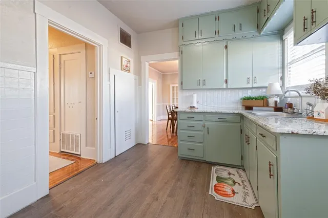 a spacious bedroom with a bed and wooden floor