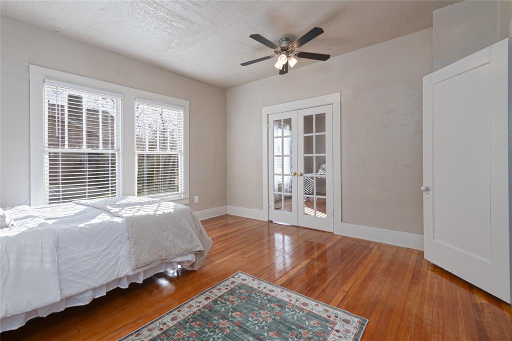 449 Clinton Street Abilene, TX 79603 - Photo 18 of 34 a spacious bedroom with a bed and wooden floor