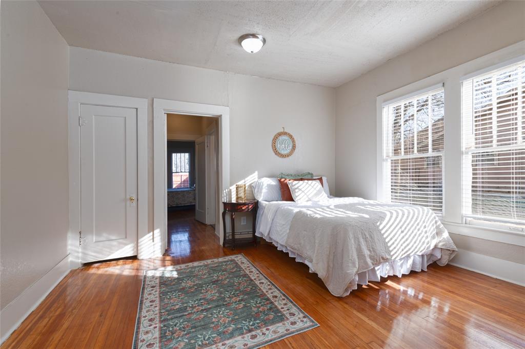 449 Clinton Street Abilene, TX 79603 - Photo 19 of 34 a spacious bedroom with a bed and wooden floor