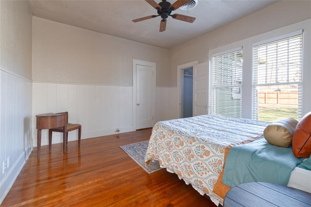 449 Clinton Street Abilene, TX 79603 - Photo 24 of 34 a bedroom with a bed and wooden floor