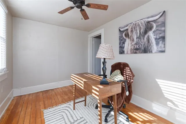 a dining room with furniture and wooden floor